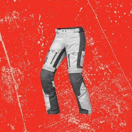 Adventure Riding Pants for Warmth and Protection on Red Background