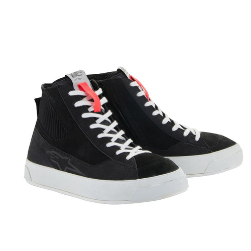 The Stella Stated Podium Shoes by Crown Kiwi Enterprises Limited are black high-top skate shoes designed with abrasion-resistant materials, featuring white soles and laces. The tongue includes a red pull tab for easy access. For a stylish display, the left shoe is positioned at an angle, slightly in front of the right.