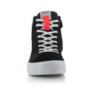 The Stella Stated Podium Shoes by Crown Kiwi Enterprises Limited are black high-top skate shoes designed with abrasion-resistant materials, featuring white soles and laces. The tongue includes a red pull tab for easy access. For a stylish display, the left shoe is positioned at an angle, slightly in front of the right.