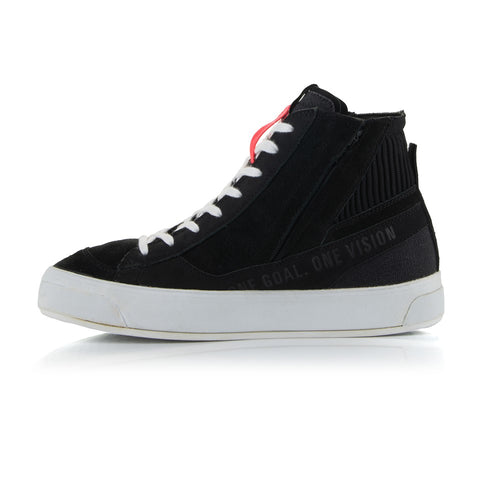 The Stella Stated Podium Shoes by Crown Kiwi Enterprises Limited are black high-top skate shoes designed with abrasion-resistant materials, featuring white soles and laces. The tongue includes a red pull tab for easy access. For a stylish display, the left shoe is positioned at an angle, slightly in front of the right.