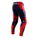 The Troy Lee Designs SE Ultra Pant Lucid Black/Red features red, blue, and black gradient design, white "Troy Lee" logo on the right thigh, laser perforated ventilation, and padded knee areas for motocross performance.