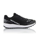 A pair of black athletic shoes, the Meta Road v2 Shoes from Crown Kiwi Enterprises Limited, featuring white soles and "alpinestars" printed on the side. These lightweight shoes boast a sleek design with a star logo, offering a breathable fit and textured sole for enhanced grip.