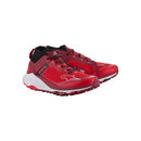 The Meta XR v2 Shoes by Crown Kiwi Enterprises Limited boast vibrant red hues, tailored specifically for off-road running. Designed for all-day comfort, these trail running shoes feature black accents and durable soles. The intricate design elements beautifully complement the Meta XR v2 branding on the sides, all presented against a plain white background.
