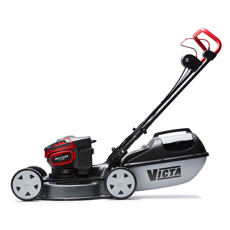 The Victa Corvette Twin 18" 18V Lawnmower - Kit features a sleek design with a black and red finish, complemented by a plastic grass collection bag at the rear. It includes a handlebar for easy pushing and four wheels for smooth maneuverability. Powered by Briggs & Stratton Batteries with advanced brushless motor technology, the mower proudly displays the "Victa" brand name on the side of its deck.