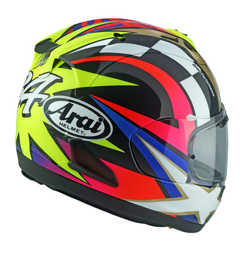 A side view of a colorful motorcycle helmet with intricate patterns in black, white, red, yellow, and blue. The Arai RX-7V EVO - Schwantz 30 prominently displays the number 74 and the ARAI brand logo on its side. This Kevin Schwantz Helmet features a clear visor and a sleek, aerodynamic design that meets ECE R22-06 standards.