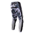 The Troy Lee Designs GP PRO PANT BLENDS CAMO BLACK / WHITE features white graphics and logos on black, made from durable 600D polyester with reinforced knee panels and a partially elastic waistband, shown against a white background.