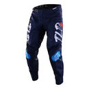 The Troy Lee Designs GP PRO Pant Partical Navy/Orange features navy blue with white and blue graphics, bold thigh lettering, a red accent, durable 600D polyester, reinforced knees, and a black waistband.