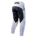The Troy Lee Designs GP PRO AIR PANT APEX in Charcoal/Gray features reinforced knee panels, black logo graphics, and a secure waist closure for protection and flexibility during motocross riding.