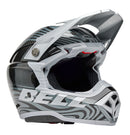 The Bell MOTO-10 SPHERICAL Cortex Gloss Silver/Grey helmet showcases a sleek, modern motocross design with a gray and black swirling pattern. It features angular lines, a visor peak, and incorporates MIPS technology for enhanced safety. The brand name "BELL" is prominently displayed on the side.