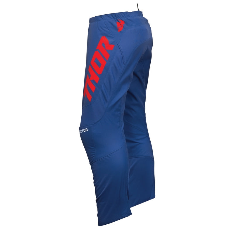 The THOR SECTOR CHECKER PANTS in NAVY/RED, part of the Sector Collection by THOR MX, are designed for rider mobility and comfort with reinforced knees and a tapered fit to enhance durability during sports activities. They feature red lettering on the side.