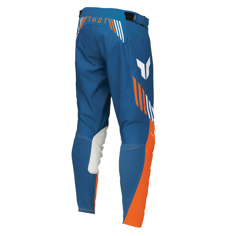 The THOR PANTS LAUNCH ZONE BLUE by THOR MX offer precision-fit comfort with their blue and orange poly stretch fabric, accented by white details. These motocross pants feature reinforced knee areas and ventilation for improved performance, incorporating a white wing-like logo and a white stripe pattern on the sides, exemplifying the LAUNCHMODE excellence.