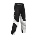 THOR MX presents the Launch Youth Storm Black pants, designed for motocross enthusiasts. These black and white pants feature "THOR" written vertically on the upper left thigh and are part of the esteemed Launch collection. They boast reinforced knee areas, durable full-grain leather accents, and a secure adjustable waistband, making them ideal for off-road biking and racing.