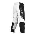 THOR MX presents the Launch Youth Storm Black pants, designed for motocross enthusiasts. These black and white pants feature "THOR" written vertically on the upper left thigh and are part of the esteemed Launch collection. They boast reinforced knee areas, durable full-grain leather accents, and a secure adjustable waistband, making them ideal for off-road biking and racing.