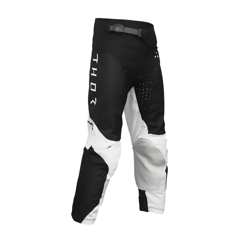 THOR MX presents the Launch Youth Storm Black pants, designed for motocross enthusiasts. These black and white pants feature "THOR" written vertically on the upper left thigh and are part of the esteemed Launch collection. They boast reinforced knee areas, durable full-grain leather accents, and a secure adjustable waistband, making them ideal for off-road biking and racing.