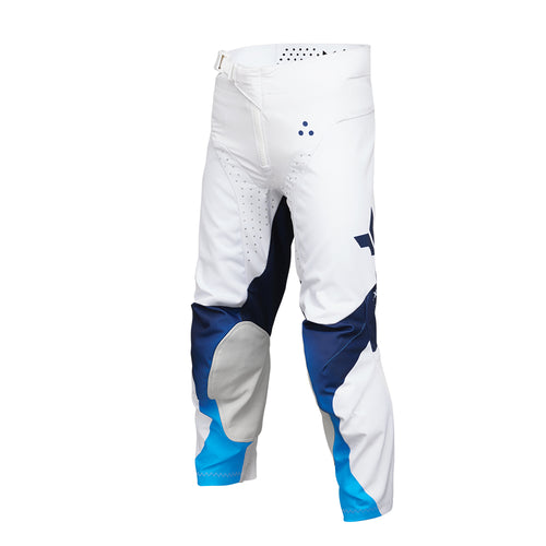 The THOR MX Launch Youth Storm White pants are crafted with durability in mind, showcasing a white fabric enhanced with blue and black accents. They feature padded knees for protection, a flexible and moisture-wicking design, and proudly display the brand name "Thor" printed vertically on the side.