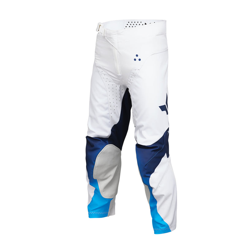 The THOR MX Launch Youth Storm White pants are crafted with durability in mind, showcasing a white fabric enhanced with blue and black accents. They feature padded knees for protection, a flexible and moisture-wicking design, and proudly display the brand name "Thor" printed vertically on the side.