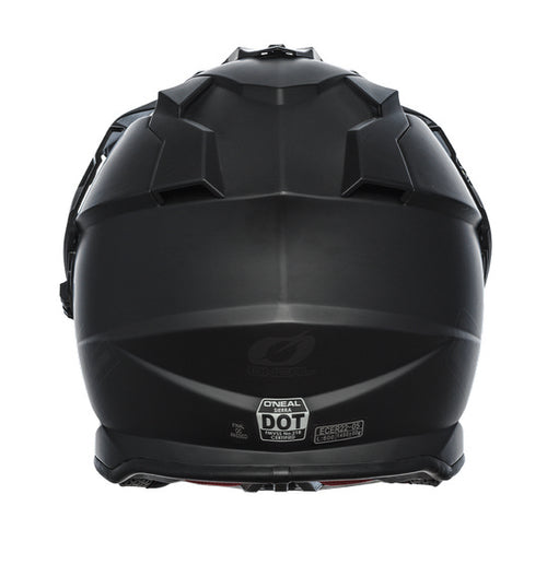 The O'Neal SIERRA Helmet R V.23 in flat black features a matte finish and angular, geometric design details on top; "ONEAL" branding is near the visor front, making it ideal for adventure bike riders.