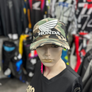 Front and rear views of the 100% cotton camouflaged Honda Cap Camo. The front features a prominent "HONDA" logo with a stylized wing above the text, while the back of the cap is black mesh with an adjustable snapback strap by HRC.