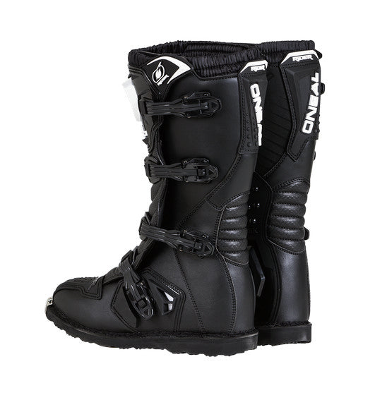 The O'Neal RIDER Boot - Black by Oneal is a pair of black motorcycle boots with white and silver details. These boots feature sturdy buckles, textured shin guards, reinforced toe caps, and a durable sole. With branding on the shin area, these boots are designed for off-road motorcycling and offer superior impact protection.