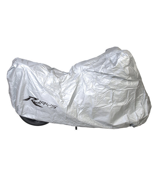 A crumpled, semi-reflective silver bike cover with the brand name "Rjays" printed on the side, fully concealing a motorcycle underneath. Only a small portion of the front wheel is visible. The durable, water-resistant RJAYS Motorcycle Cover stands out against the plain white background.