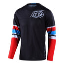 The Troy Lee Designs GP AIR JERSEY WARPED RED / BLACK is a lightweight, long-sleeved race jersey featuring black fabric, white geometric chest logo, and white, red, and blue sleeve stripes—ideal for warm weather with breathable materials.