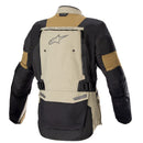 The Alpinestars Bogotá Pro Drystar Jacket, in tan, black, and beige with orange accents, offers a high collar and multiple zippered pockets. This all-season ALPINESTARS jacket ensures waterproof protection and durability with its reinforced materials.
