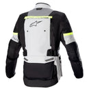 The Alpinestars Bogota Pro Drystar Jacket in gray and black prominently features "alpinestars" on the left chest. It has multiple pockets, zipper details, neon yellow for visibility, is waterproof, and includes ventilation panels for comfort in all conditions.