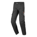 The Alpinestars AMT-8 Stretch Drystar XF Pants by ALPINESTARS are black, featuring articulated knees, multiple zippered pockets, a star-like logo on the right thigh, and an adjustable waist buckle. They're made from durable Drystar®XF fabric for adventure riding and outdoor activities.
