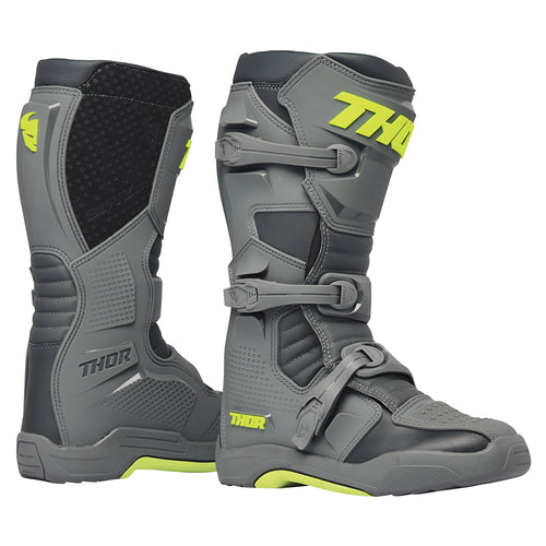 The THOR MX Blitz XR Boots GY/CH feature a gray and black motocross design with neon yellow accents and prominently display the "THOR" brand name on the side. These boots are crafted from synthetic materials, incorporating adjustable straps, reinforced panels, and injection molded components to enhance durability and protection.