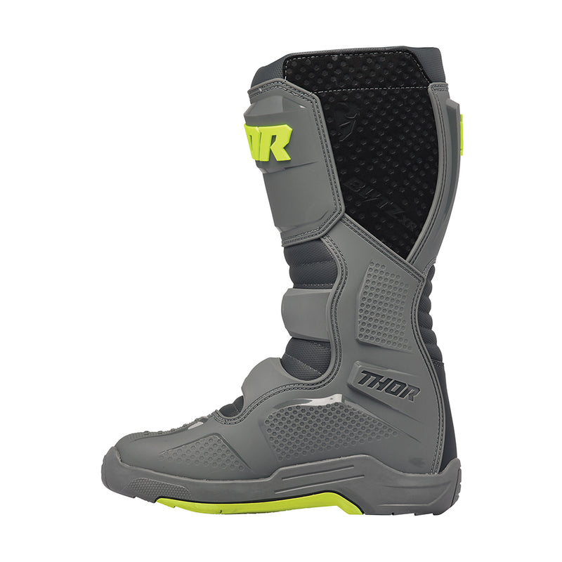 The THOR MX Blitz XR Boots GY/CH feature a gray and black motocross design with neon yellow accents and prominently display the "THOR" brand name on the side. These boots are crafted from synthetic materials, incorporating adjustable straps, reinforced panels, and injection molded components to enhance durability and protection.