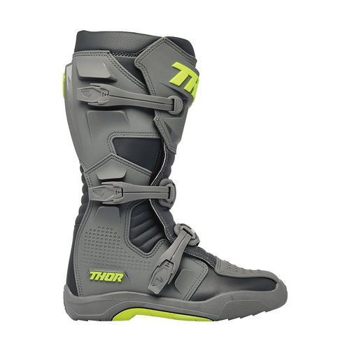 The THOR MX Blitz XR Boots GY/CH feature a gray and black motocross design with neon yellow accents and prominently display the "THOR" brand name on the side. These boots are crafted from synthetic materials, incorporating adjustable straps, reinforced panels, and injection molded components to enhance durability and protection.