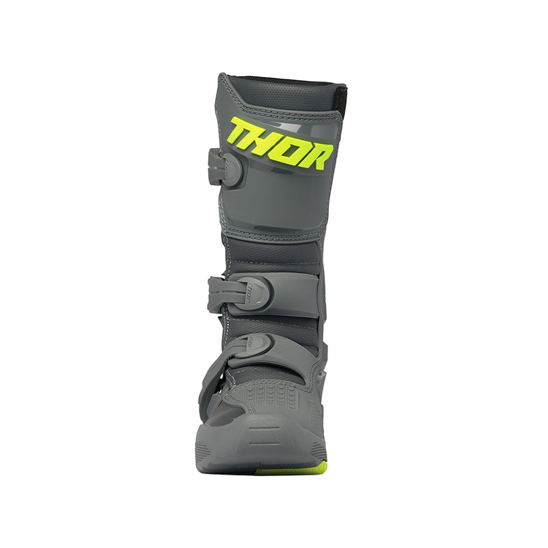 A pair of THOR MX Blitz XR youth boots in gray and charcoal, accented with neon yellow. Made from synthetic materials, they feature multiple adjustable straps and textured soles. One boot is positioned upright while the other is angled to display its back and side profile. Both boots prominently showcase the Thor logo.