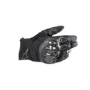 The ALPINESTARS SMX-1 Drystar Gloves are black motorcycling gloves with reinforced knuckles, showcasing a sleek design from the side to highlight their ergonomic fit and impact protection.