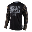 The SCOUT GP JERSEY PEACE & WHEELIES CAMO GREEN by Troy Lee Designs features camo sleeves, "Troy Lee Designs" and "Pop Wheelies" on the front, a peace sign graphic, and a checkered pattern—crafted from TLD Dura Knit Fabric.