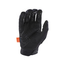 The Troy Lee Designs GAMBIT GLOVE BLACK features a checkered pattern, white branding, logo patches, an orange wrist tag, visible ventilation holes, and three-layer softshell construction for comfort.