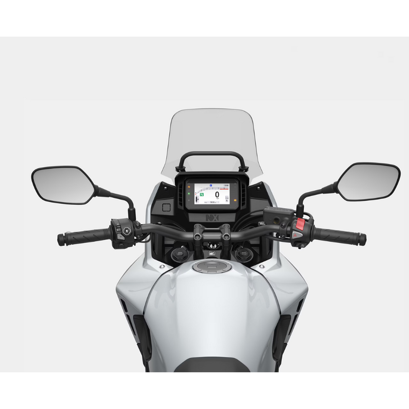 The Honda NX500, a sleek and modern motorcycle by Honda, showcases a silver and black color scheme with programmed fuel injection. It features a prominent windshield, angular design elements, and alloy wheels. The side profile accentuates its sporty and aerodynamic build.
