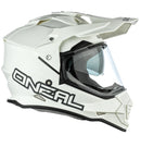 The front view of the O'Neal SIERRA Helmet R V.23 in Flat White showcases its angular design and geometric patterns. Designed by ONEAL, this stylish helmet is perfect for adventure bikes, featuring an integrated face shield, a small visor, and prominent branding—ideal for both safety and style.