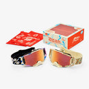 Two vibrant Armega LE Donut Goggles from Crown Kiwi Enterprises Limited are showcased with mirrored lenses and patterned straps. Featuring HiPER contrast-enhancing lenses, they include a matching red pouch on the left and a lively box saying "Thank you for racing with us!" in the background.