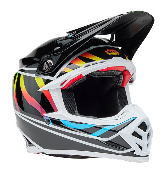 The Bell MOTO-9S FLEX Drift helmet by BELL, in Gloss Black/Multi, features vibrant red, blue, yellow, and orange stripes. It includes a pointed visor, side logo, aerodynamic design with chin guard, and efficient ventilation system for comfort-focused safety.