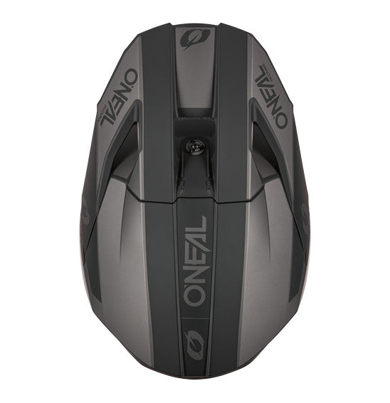 The O'Neal 2026 3SRS SOLID Helmet in black/grey by ONEAL offers full-face coverage, a visor, chin guard, and vent openings. Its angular ABS shell design features the ONEAL logo on the side and visor.