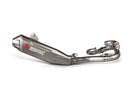 The Akrapovic Full Ti System YZ450F 2023 exhaust, from AKRAPOVIC, is a sleek titanium alloy design for weight reduction. It features a metallic finish, tapered end, curved piping, and sturdy mounting brackets with "Akrapovic" in red and white lettering.