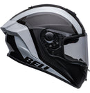 Side view of the Bell RACE STAR DLX FLEX Tantrum 2 Black/White helmet with a clear visor. The helmet boasts a sleek design with aerodynamic contours, Velocity Flow Ventilation, and a textured pattern on the top and sides. A Carbon Fiber Shell ensures durability, while the BELL logo is prominently displayed.