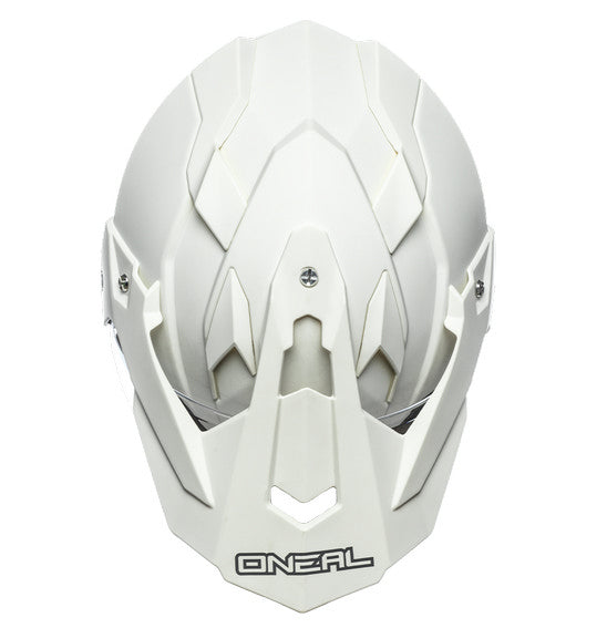 The front view of the O'Neal SIERRA Helmet R V.23 in Flat White showcases its angular design and geometric patterns. Designed by ONEAL, this stylish helmet is perfect for adventure bikes, featuring an integrated face shield, a small visor, and prominent branding—ideal for both safety and style.