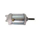The STARTER MOTOR RICKS MOTORSPORT SUZUKI by RICK'S is a cylindrical electric device with a metallic finish, featuring mounting brackets on both ends and a protruding black shaft. The motor is primarily silver with some weathered or polished texture, and there is a brass screw visible near the center. It comes with a one-year product warranty.