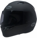 A Bell QUALIFIER Matte Black full-face motorcycle helmet is shown from a side angle, featuring an aerodynamic design with a smooth matte finish and a clear visor. The helmet includes a top vent for airflow, the "Bell" logo on the side, and Multi-Density EPS Liner for enhanced safety.