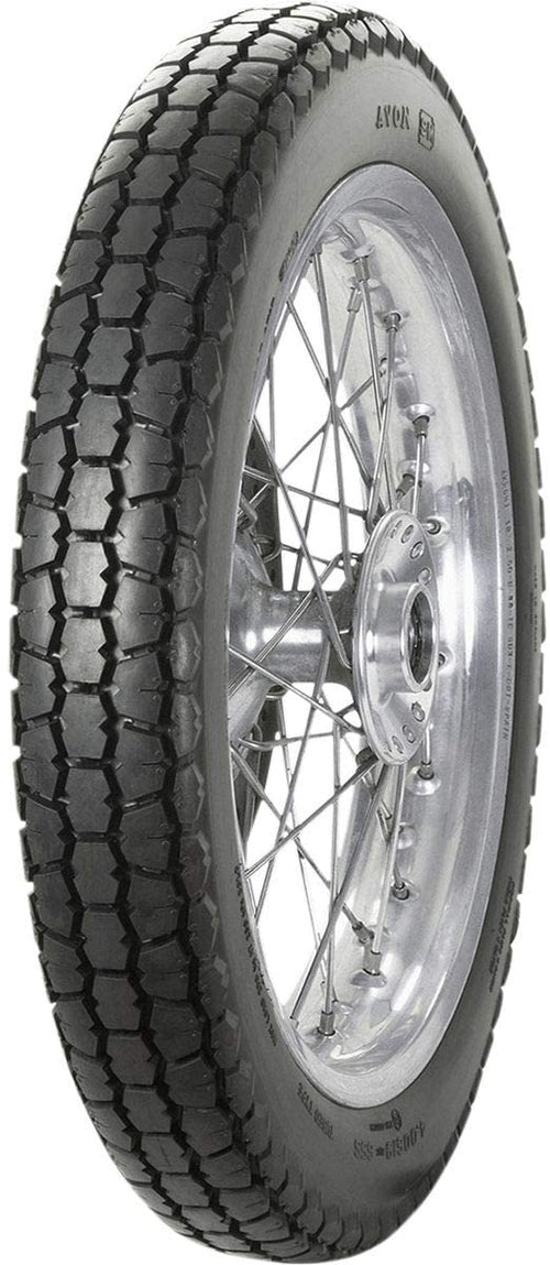 A black Avon Vintage and Classic Tire by Avon Tyres with a shiny silver rim shows a classic tread of thin parallel grooves on its circumference, set against a plain white background.