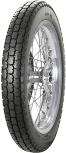 A black Avon Vintage and Classic Tire by Avon Tyres with a shiny silver rim shows a classic tread of thin parallel grooves on its circumference, set against a plain white background.