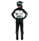 A person wearing a black and multi-colored O'Neal 2025 Youth ELEMENT Rancid Jersey, complete with helmet, gloves, pants, and boots stands with their back to the camera. The riding gear features breathable material adorned with various graphics and logos, the most prominent being "ONEAL Element" in colorful graffiti style on the back.