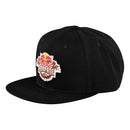 The Troy Lee Designs RAMPAGE LOGO HAT BLACK is a strapback hat with a flat brim, featuring a vibrant "Redbull Rampage" patch with mountain art and two red bulls—ideal for expressing your adventurous style.