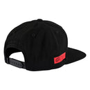 The Troy Lee Designs RAMPAGE LOGO HAT BLACK is a strapback hat with a flat brim, featuring a vibrant "Redbull Rampage" patch with mountain art and two red bulls—ideal for expressing your adventurous style.